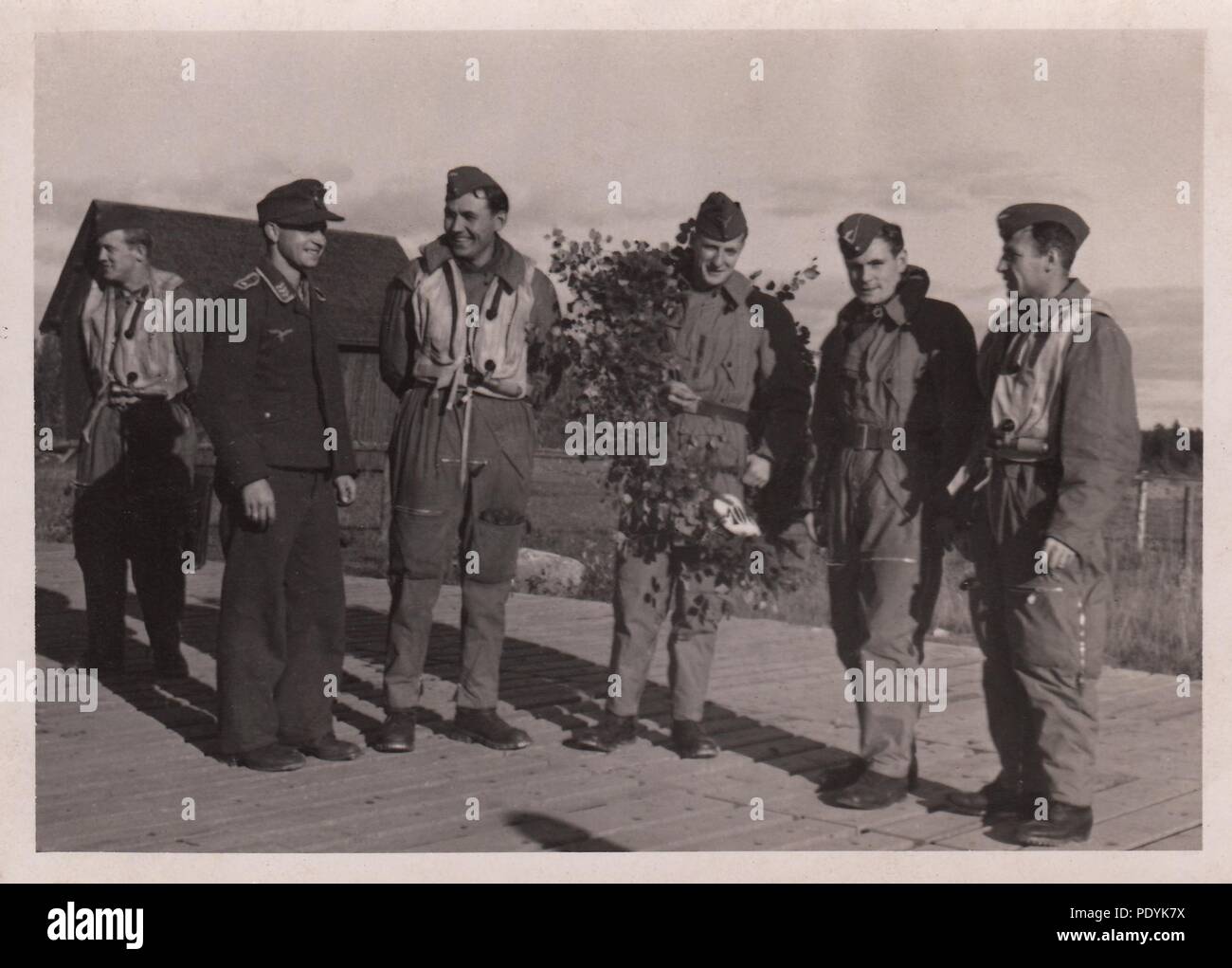 Image from the photo album of Feldwebel Willi Hoffmann of 5. Staffel, Kampfgeschwader 30: Willi Erkens and his crew from 5./KG 30 celebrate their 100th mission in the autumn of 1942. From left to right: unknown airman, unknown Feldwebel, Feldwebel Willi Hoffmann (Air Gunner), Oberfeldwebel Otto Bienmüller (Radio Operator), Leutnant Willi Erkens (Pilot), Oberfeldwebel Richard Müller (Observer). The entire crew failed to return from a mission in the Mediterranean on 23rd January 1943. Stock Photo