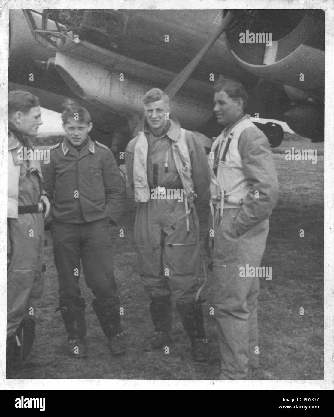 Image from the photo album of Feldwebel Willi Hoffmann of 5. Staffel, Kampfgeschwader 30: Willi Erkens and his crew from 5./KG 30 pose in front of their Junkers Ju 88 bomber in 1940. From left to right; Unteroffizier Willi Erkens (Pilot), Unknown Unteroffizier, Unteroffizier Otto Beinmüller (Radio Operator), Gefreiter Willi Hoffmann (Air Gunner). Stock Photo