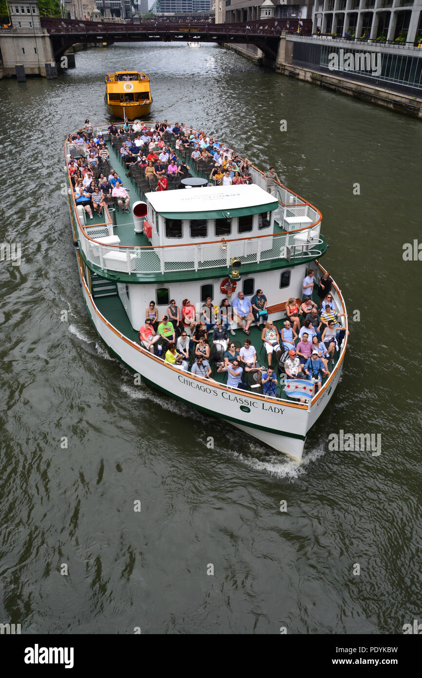 Tourists take in the city from the top deck of Chicago's Classic Lady on one of the popular Chicago Architectural Foundation river tours. Stock Photo