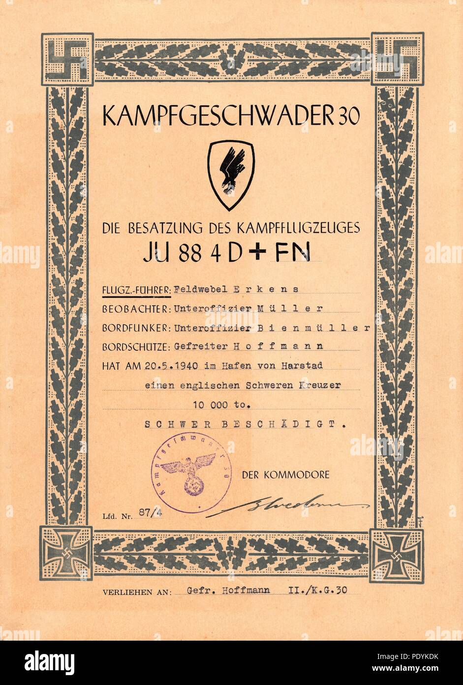 Certificate awarded to Feldwebel Willi Hoffmann of 5. Staffel, Kampfgeschwader 30: Awarded by KG 30 to Feldwebel Willi Erkens (Pilot), Unteroffizier Richard Müller (Observer), Unteroffizier Otto Bienmüller (Radio Operator) and Gefreiter Willi Hoffmann (Air Gunner) of 5./KG 30 for severely damaging an English heavy cruiser in Harstad Harbour on 20th May 1940, while crewing Junkers Ju 88 4D+FN. The document is signed in ink by Major Erich Bloedorn, Kommodore of Kampfgeschwader 30. Stock Photo