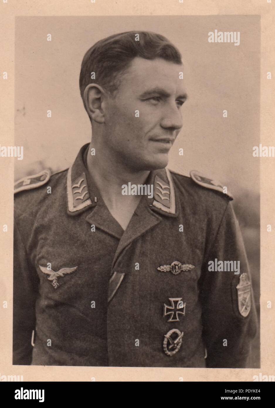 Image from the photo album of Feldwebel Willi Hoffmann of 5. Staffel, Kampfgeschwader 30: Willi Hoffmann pictured in 1942, wearing the rank insignia of a Feldwebel on his Fiegerbluse. He wears the Bomber Clasp in Gold, Narvik Shield (on his left sleeve), Iron Cross 1st Class and Air Gunner Award Badge. The Iron Cross 2nd Class ribbon is sewn to the first buttonhole of the Fliegerbluse. Willi Hoffmann and his crew failed to return from a mission in the Mediterranean on 23rd January 1943. Stock Photo