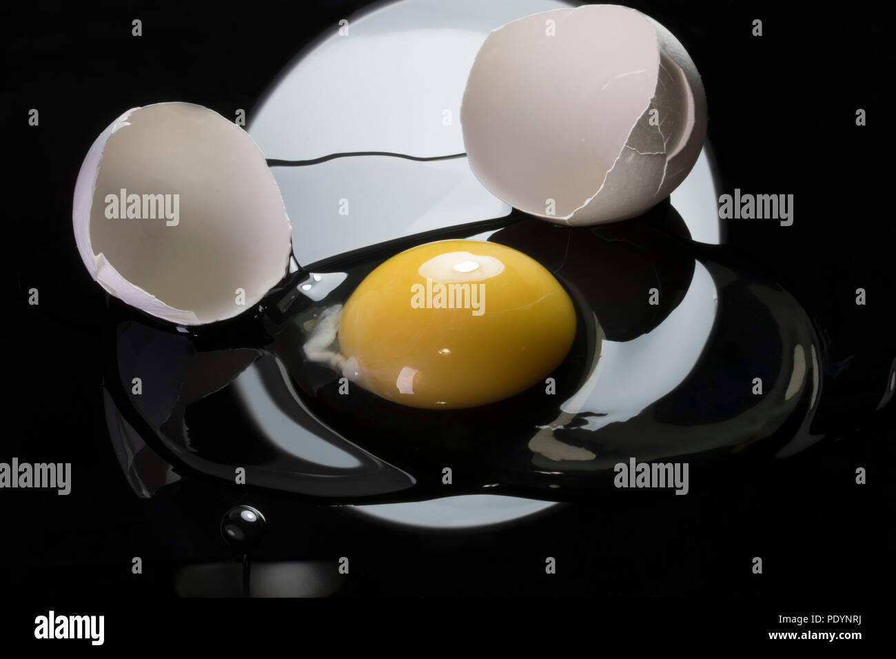 Egg yolk and eggshell isolated on black background. Ketogenic high fat