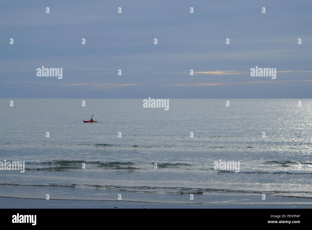 Solitary sea kayak off the coast of Borth in west Wales Stock Photo