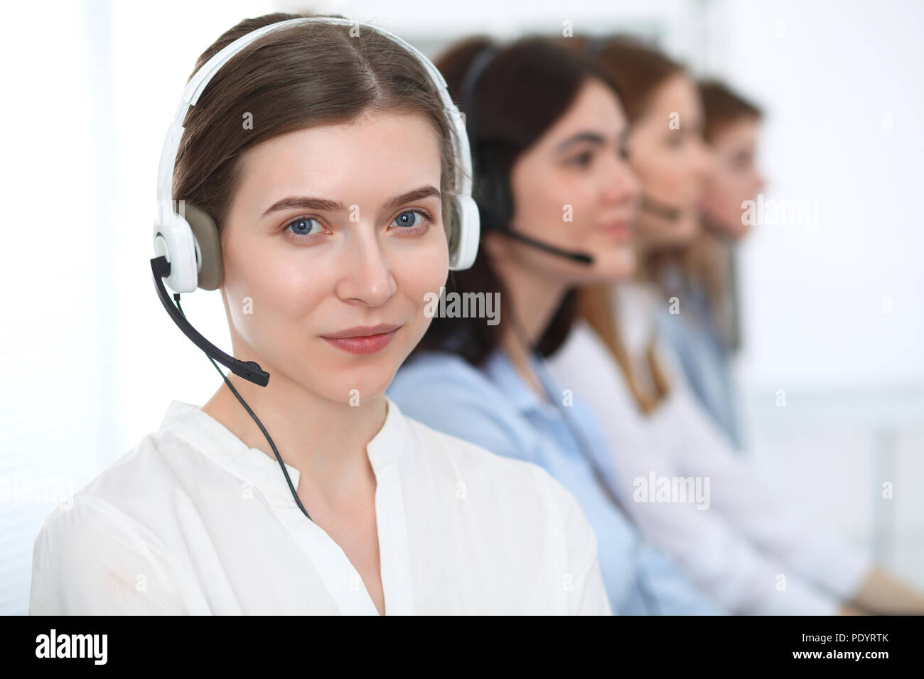 Call center. Beautiful cheerful smiling operator consulting clients
