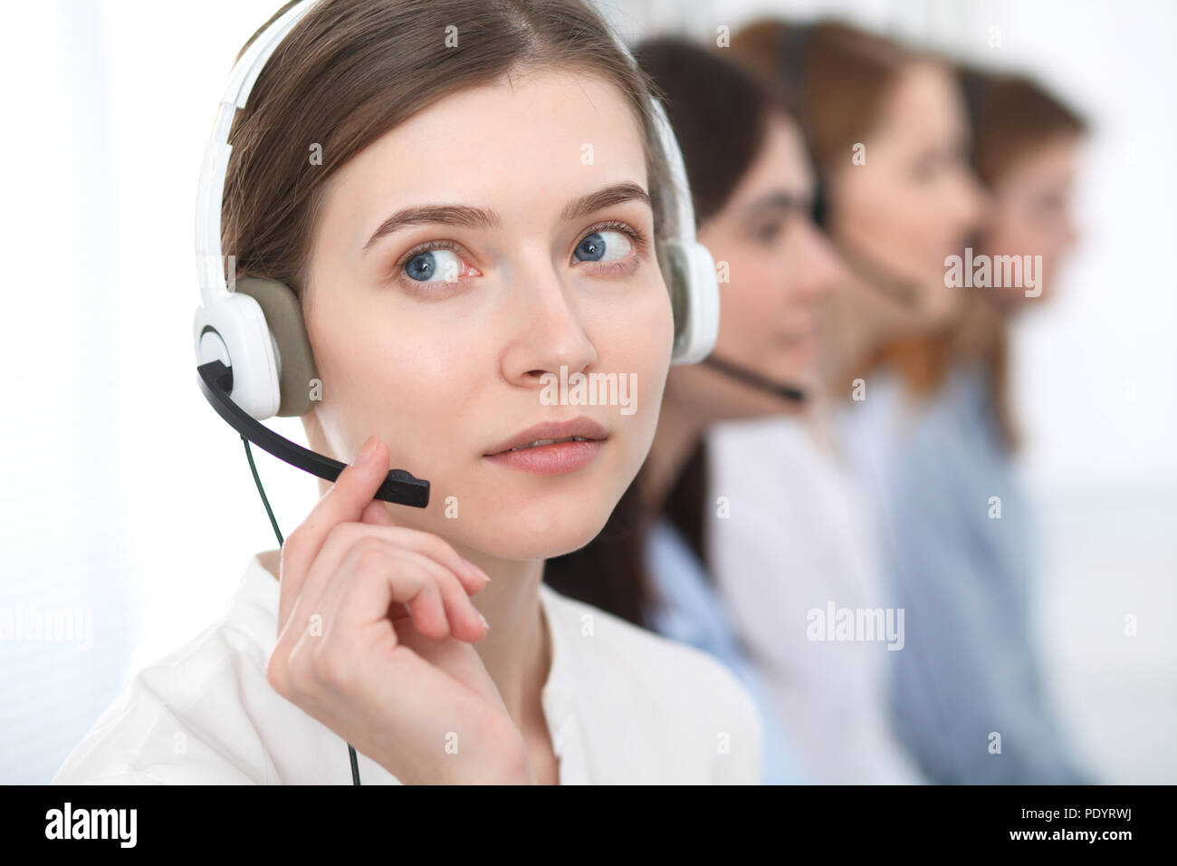 Call center. Beautiful cheerful smiling operator consulting clients