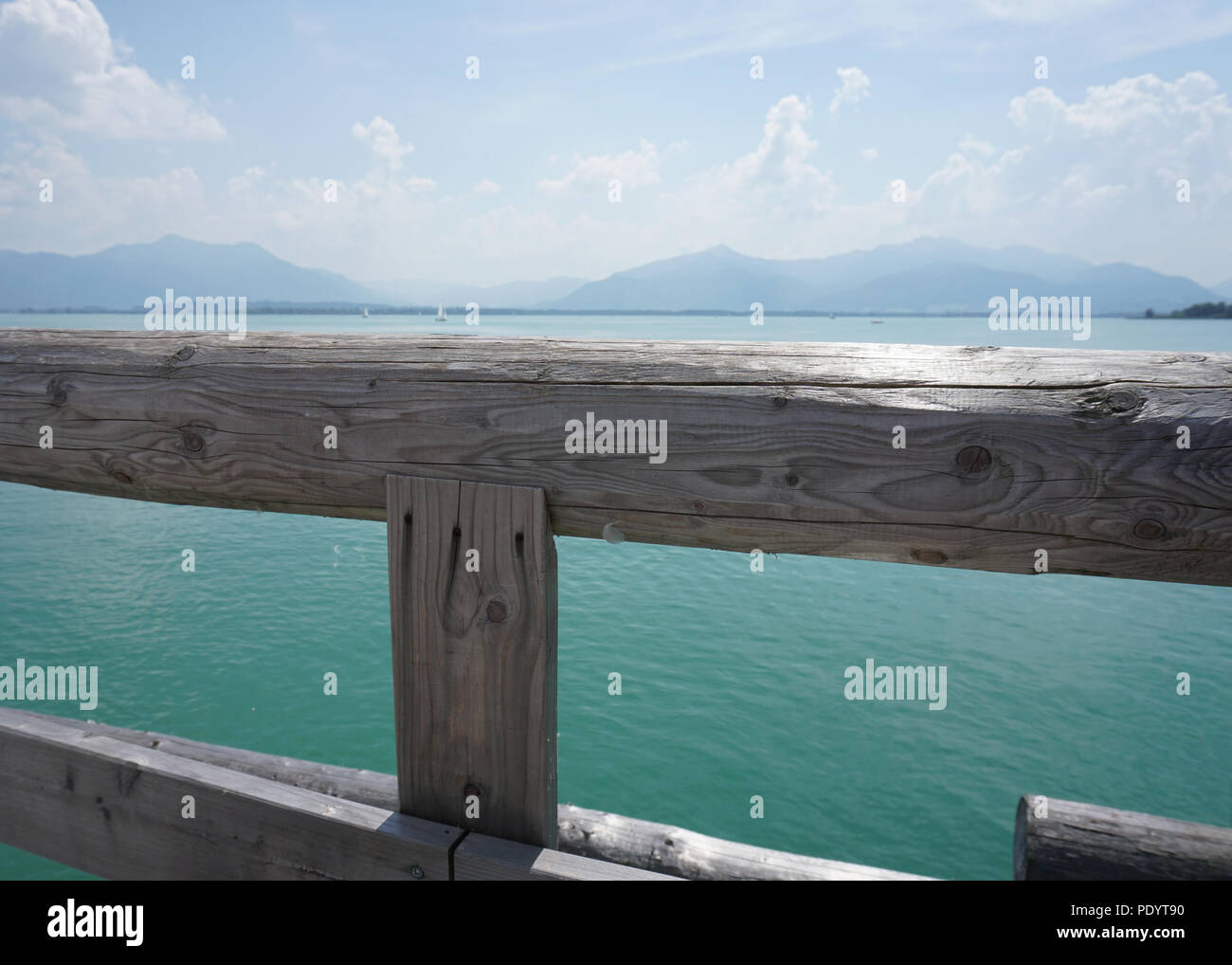 wooden balustrade and turquoise blue lake Stock Photo