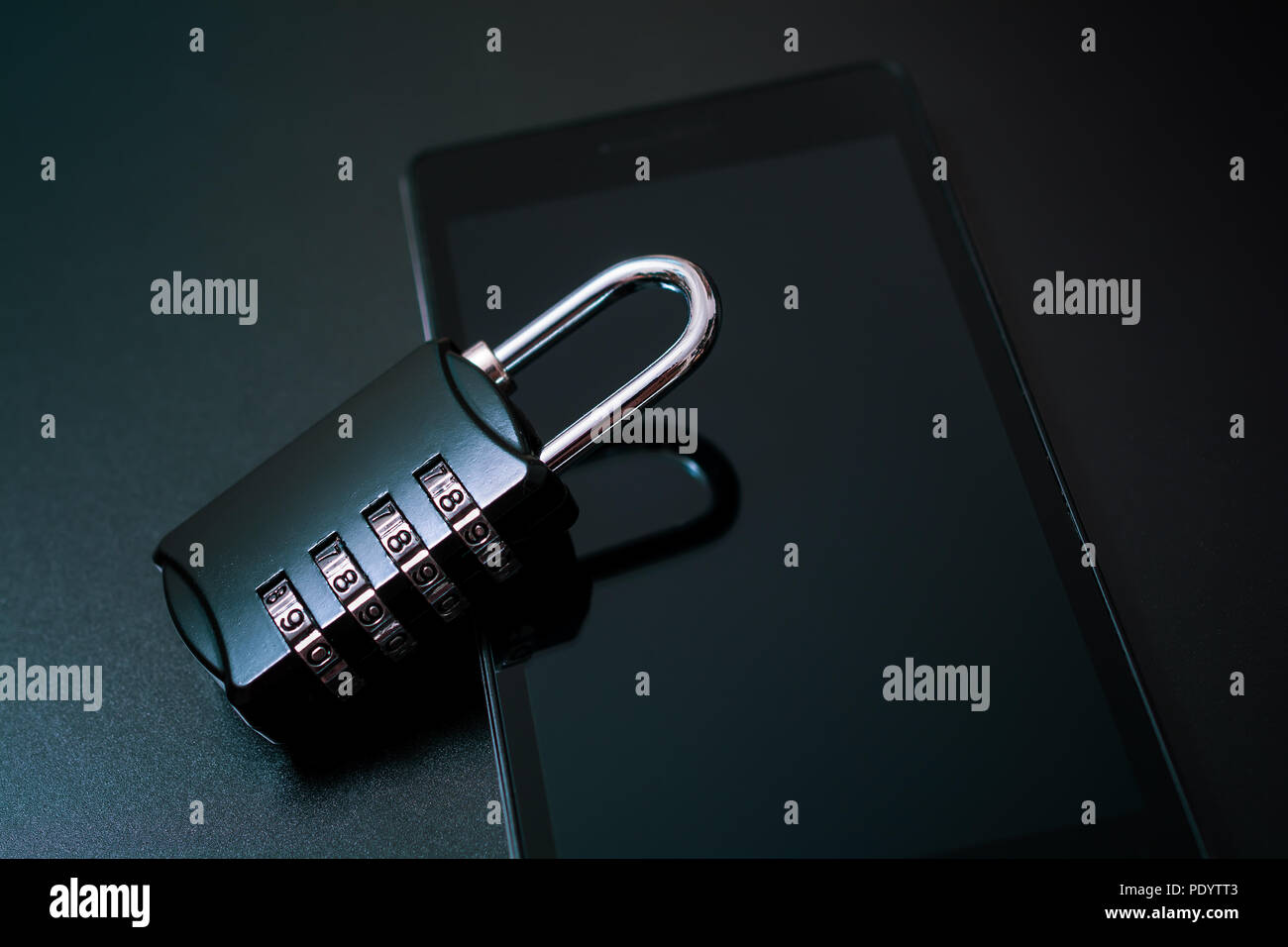 Combination Lock Leaning On A Smartphone - Mobile Phone Security Concept Stock Photo