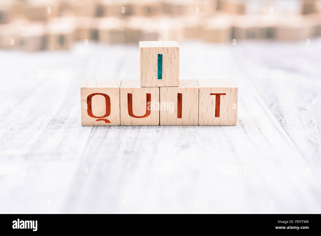 The Words I Quit Formed By Wooden Blocks On A White Table Stock Photo