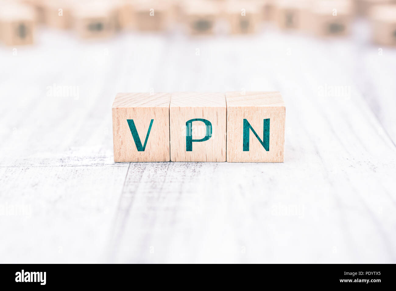 The Word VPN Formed By Wooden Blocks On A White Table Stock Photo