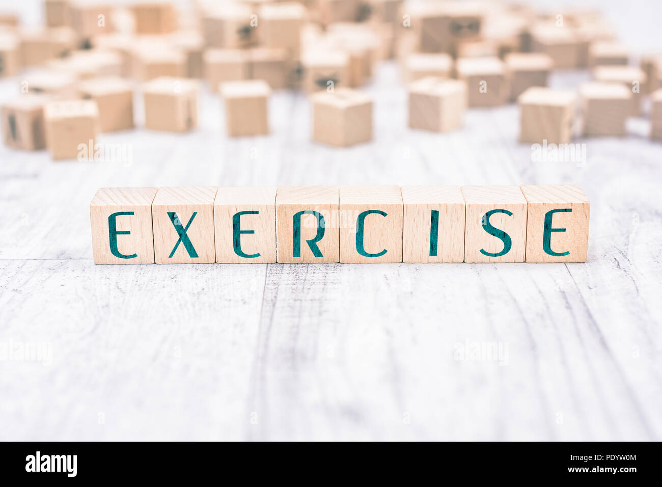 The Word Exercise Formed By Wooden Blocks On A White Table, Reminder