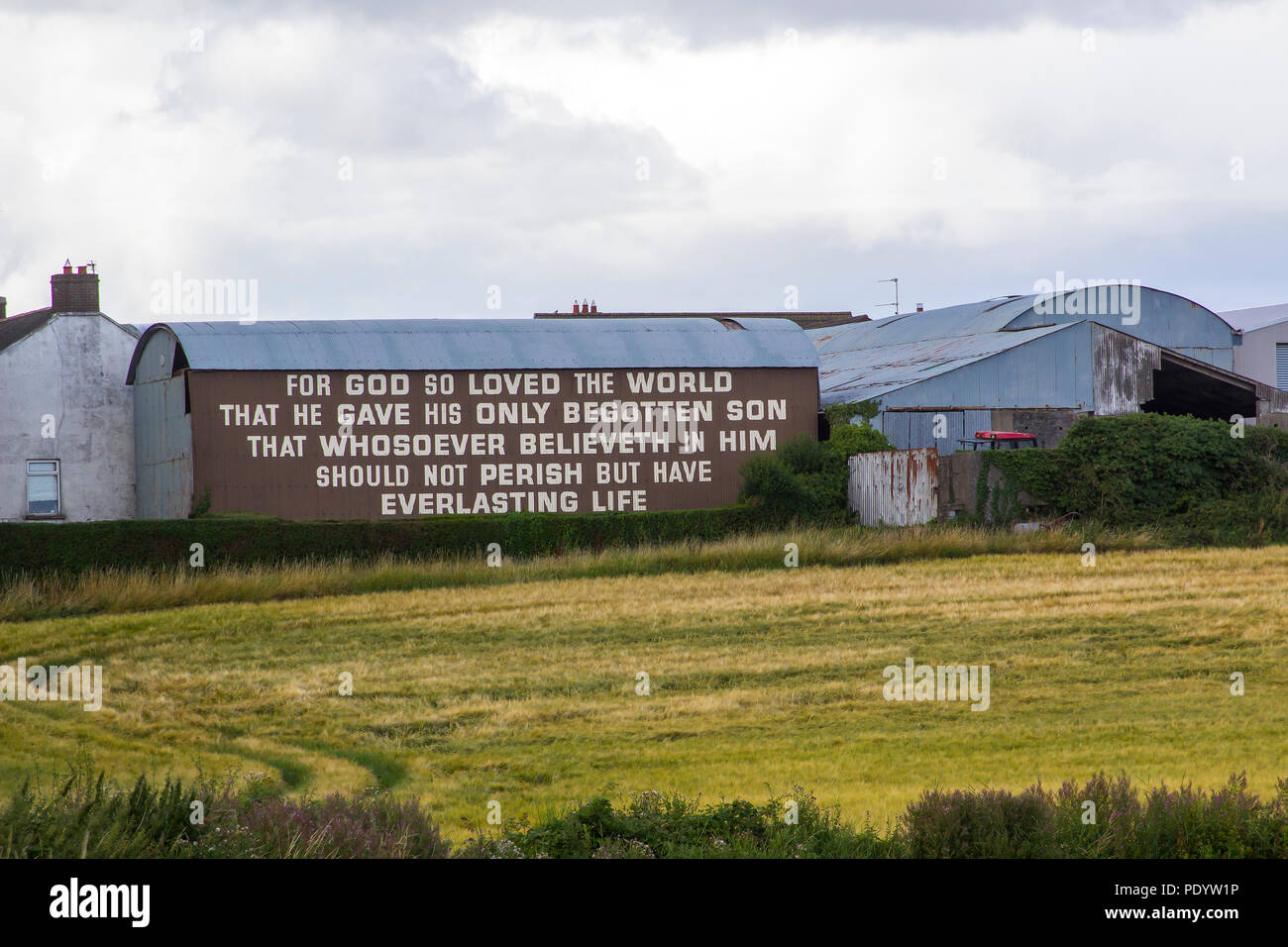 10 August 2018 The famous text of John 3 verse 16 painted in bold letters on the side of a barn on the Belfast Road at Ballygilbert, Bangor Northern I Stock Photo