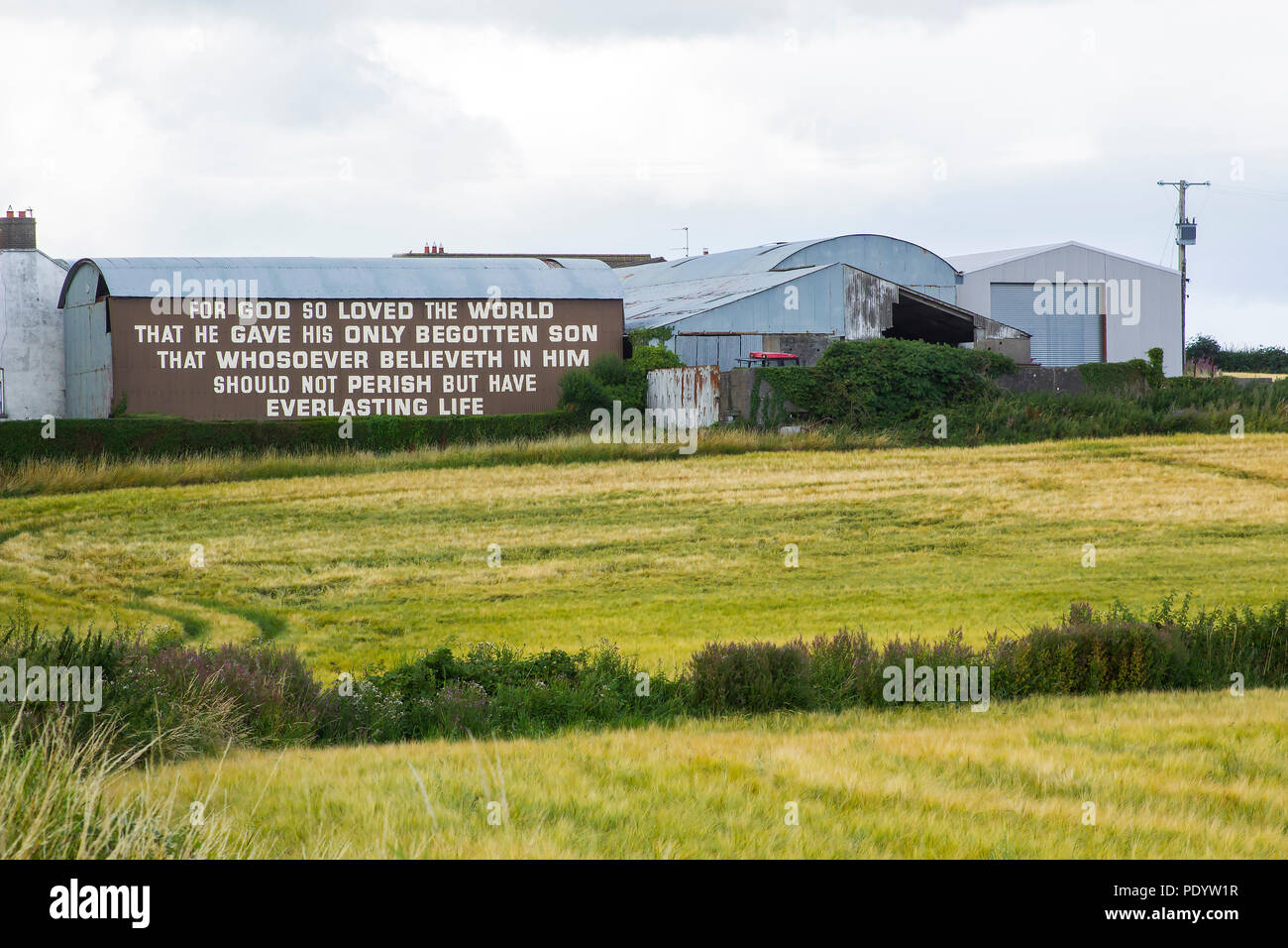 10 August 2018 The famous text of John 3 verse 16 painted in bold letters on the side of a barn on the Belfast Road at Ballygilbert, Bangor Northern I Stock Photo