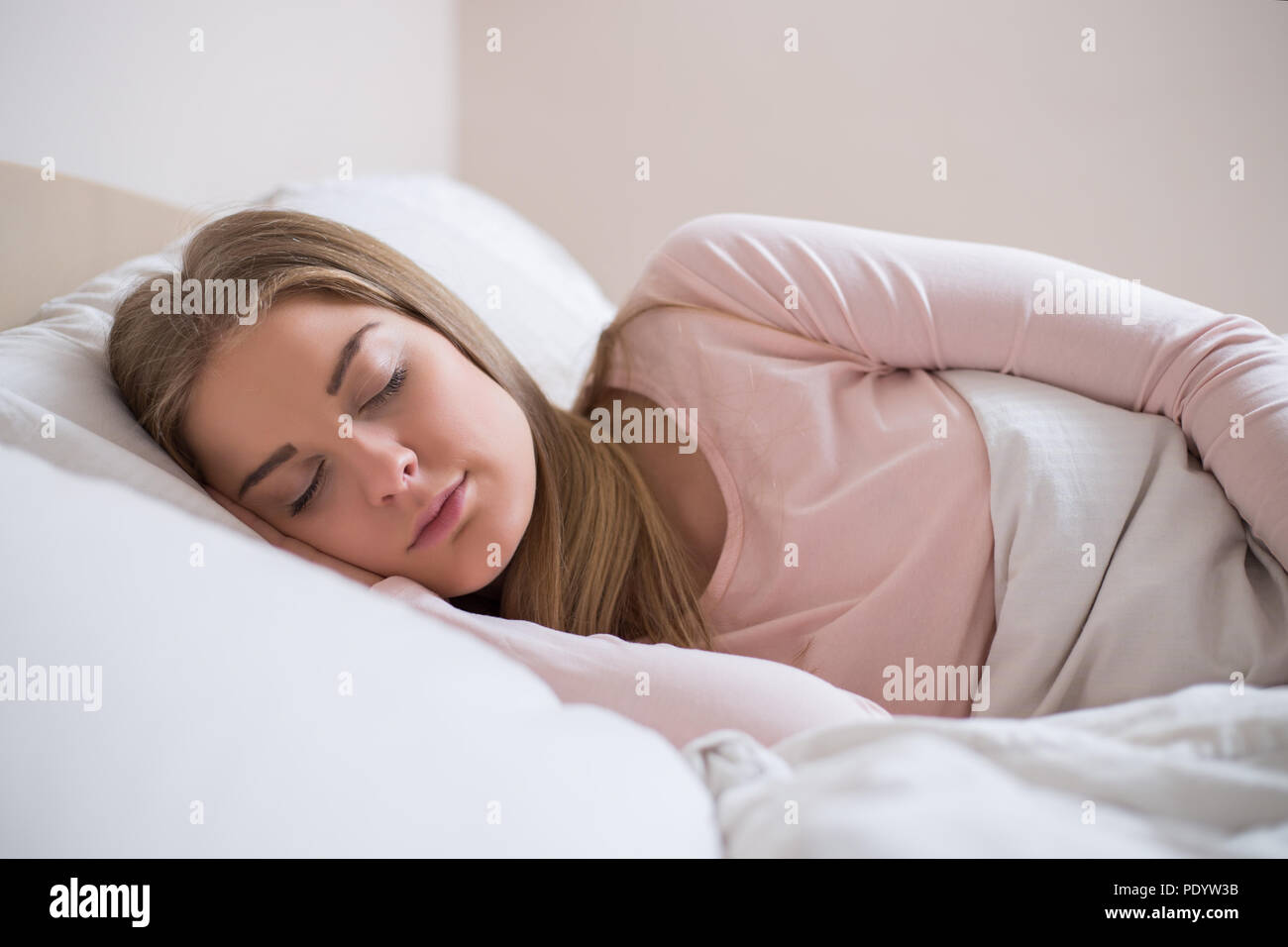 Beautiful woman in pajamas sleeping in the bedroom Stock Photo Alamy