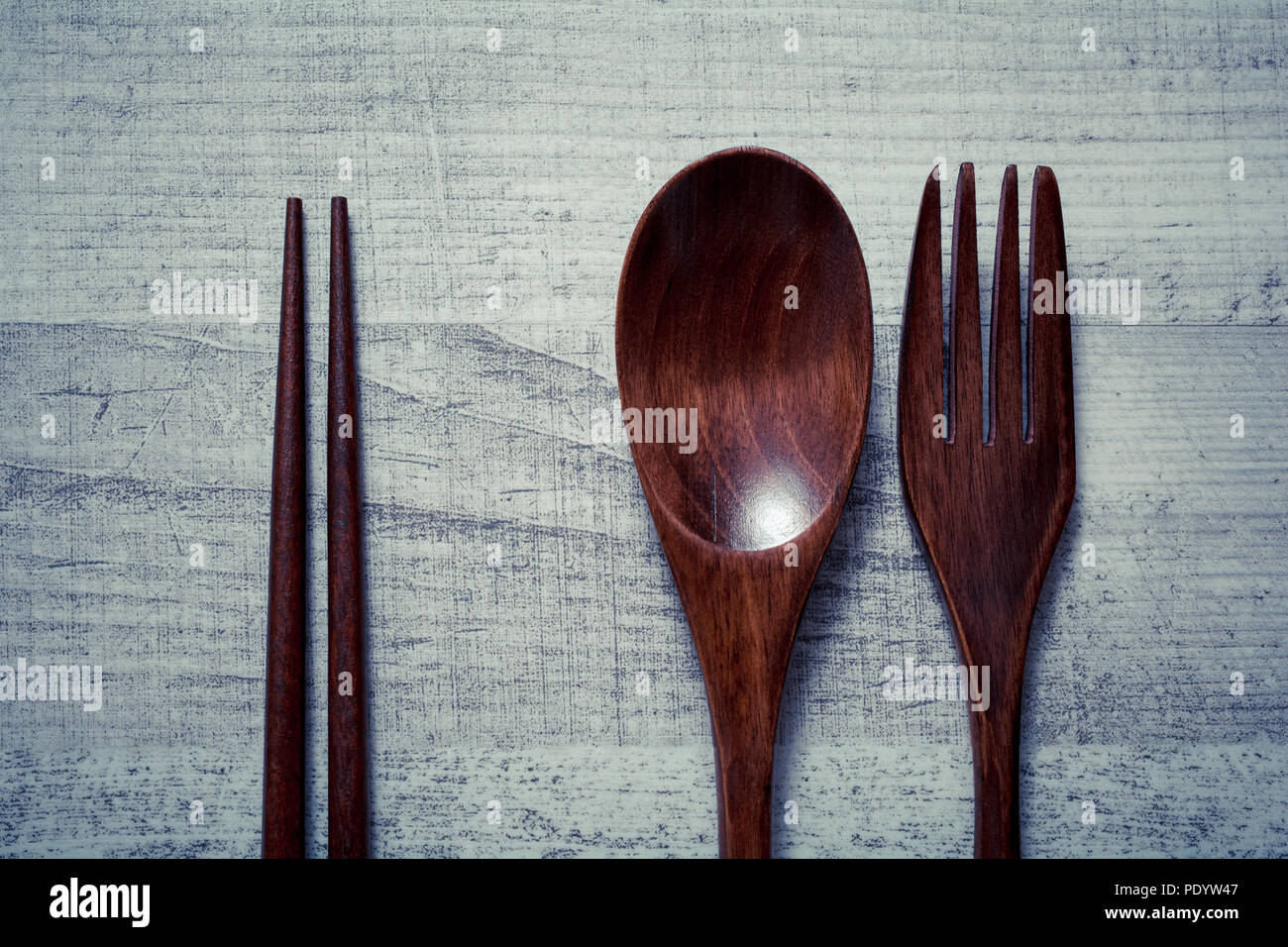 Wooden Set Of Fork, Knife And Chopsticks Lying Parallel To Each Other