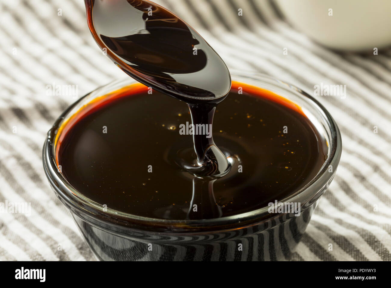 Organic Black Cane Sugar Molasses in a Bowl Stock Photo Alamy