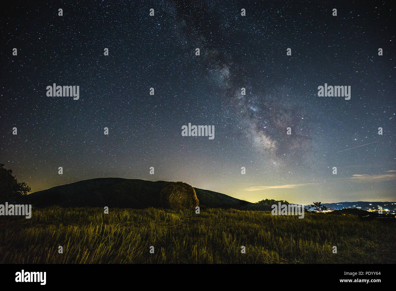Beautiful view of starred night sky with milky way over a cultivated ...