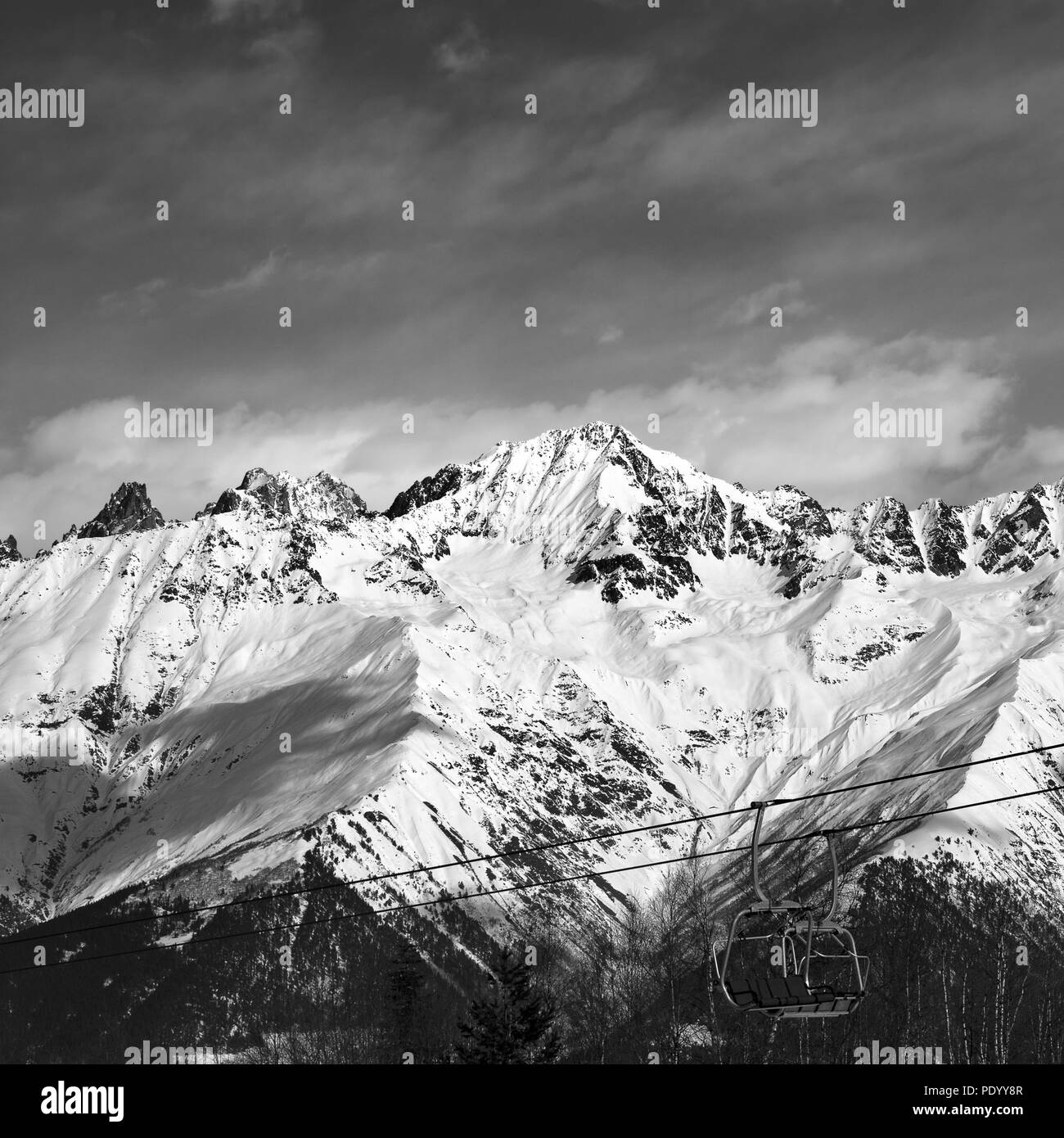 Black and white ski lift in snow mountains at nice winter day. Caucasus Mountains. Hatsvali, Svaneti region of Georgia. Square image. Stock Photo