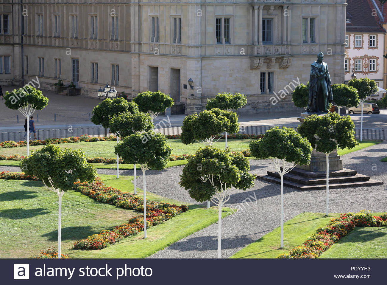 A view of a section of Castle Square (Schlossplatz) in the Franconian town of Coburg, Germany on a sunny day with shadows and a statue to Ernst I. Stock Photo
