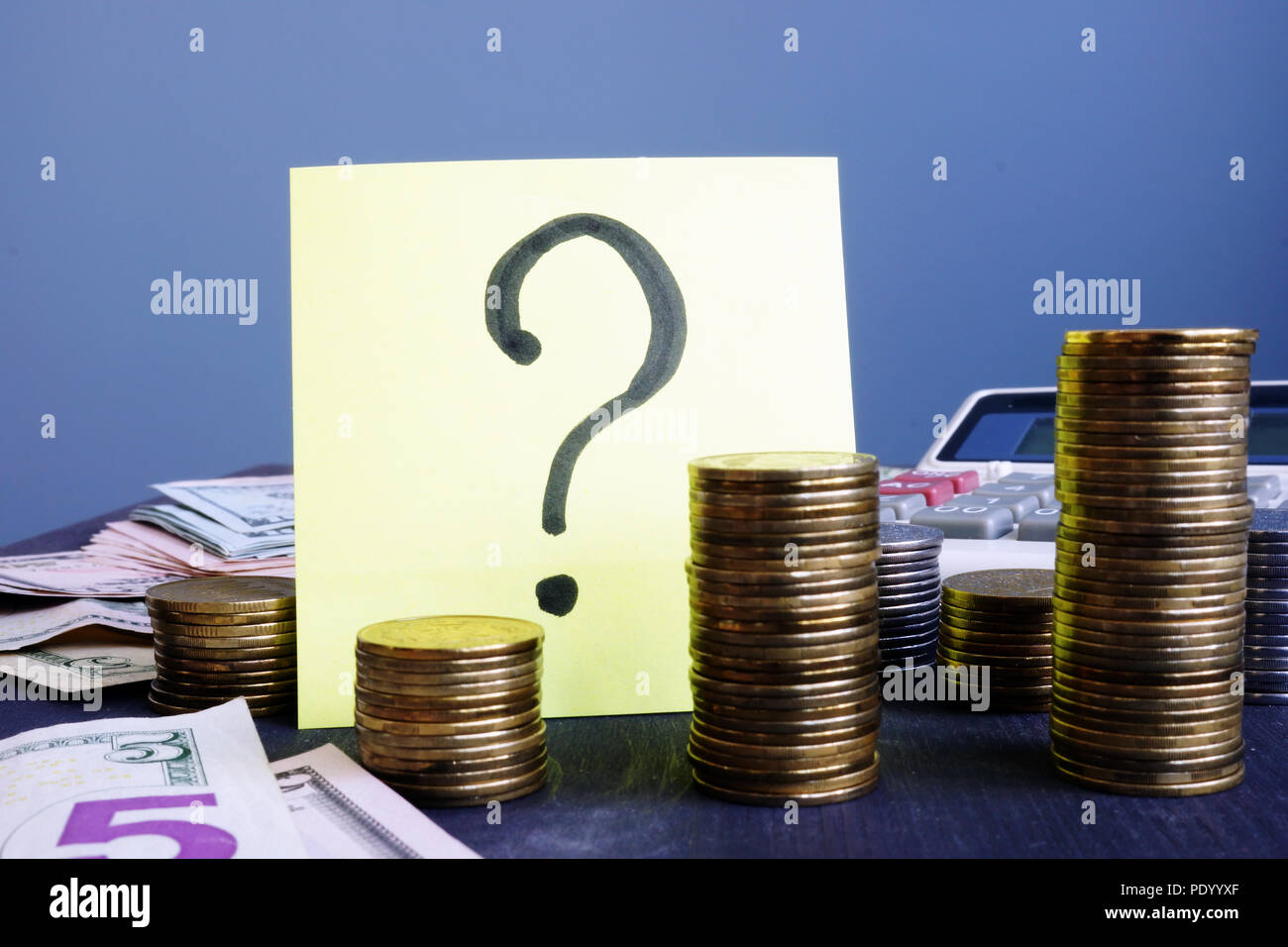 Question mark and stacks of coins. Business uncertainty concept. Stock Photo