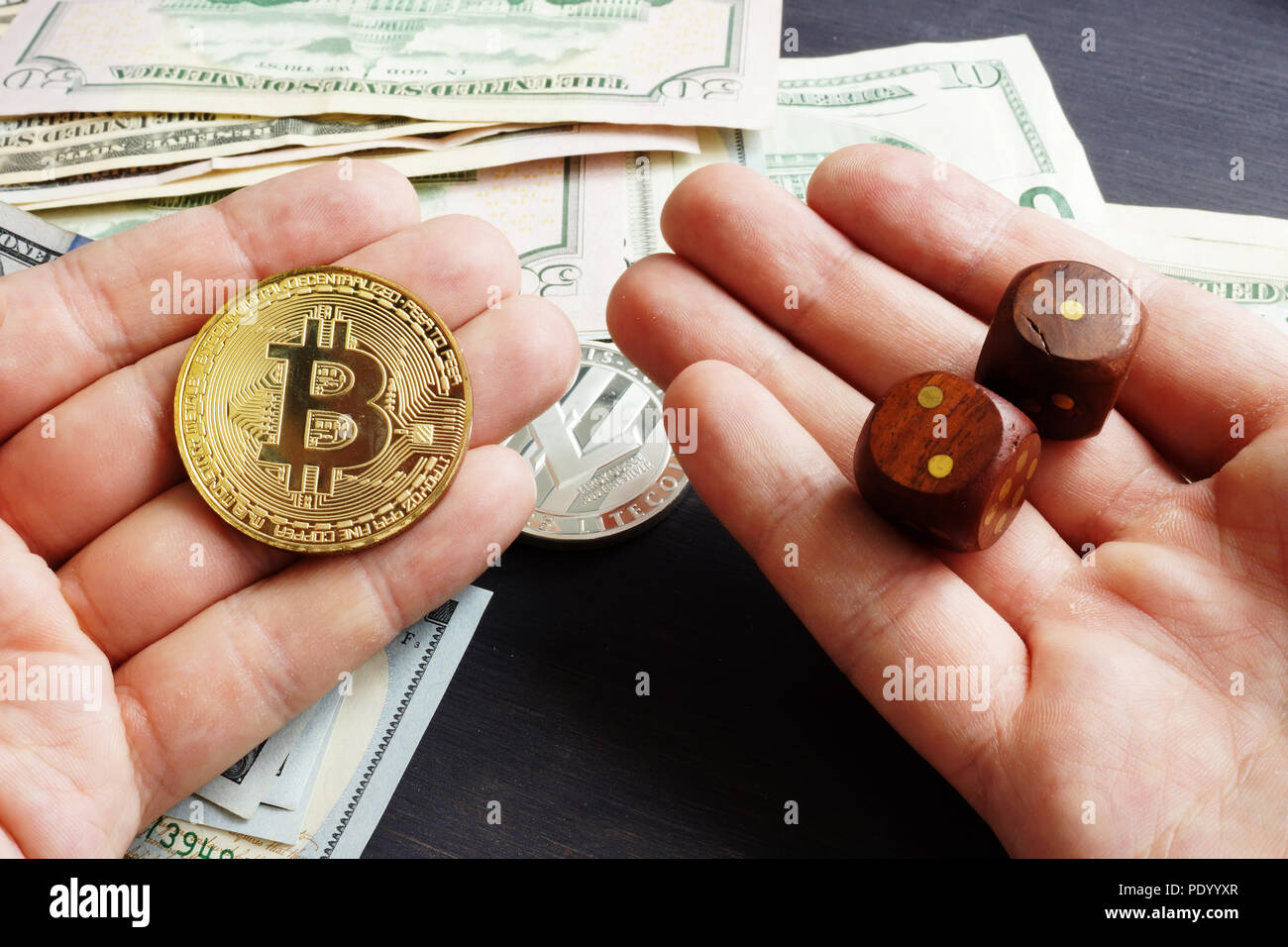Cryptocurrency market. Man is holding Bitcoin and dices. Crypto stock exchange. Stock Photo