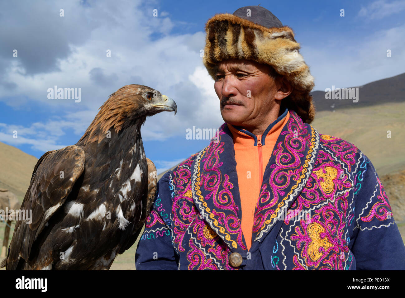 A Kazakh eagle hunter with his golden eagle in Bayan-Olgii, Mongolia. Stock Photo