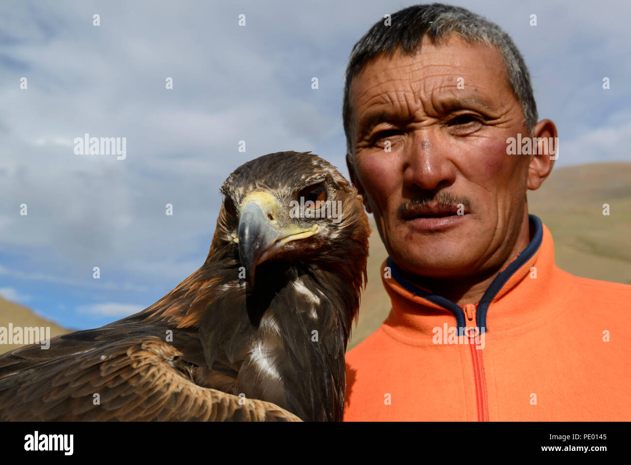 A Kazakh eagle hunter with his golden eagle in Bayan-Olgii, Mongolia. Stock Photo