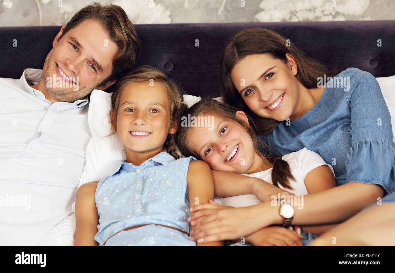 Happy family relaxing in hotel room Stock Photo