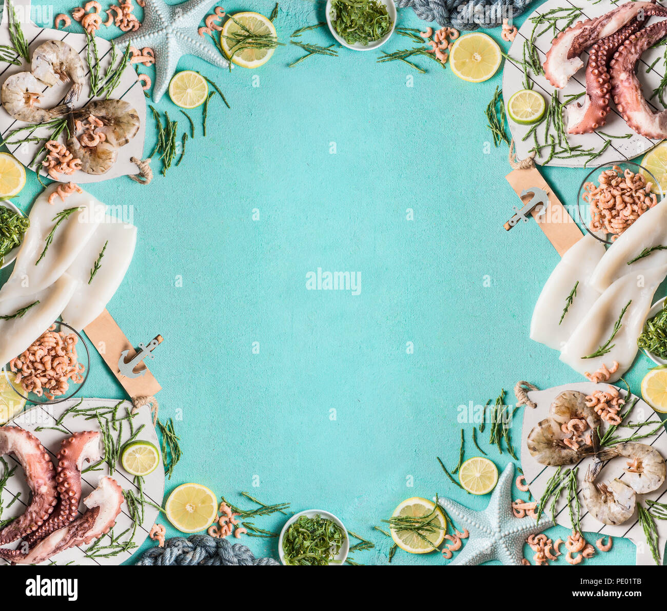Seafood frame background with squid, prawn or tiger shrimp, octopus, North Sea crabs and seaweed on light blue, top view, border. Place for your desig Stock Photo