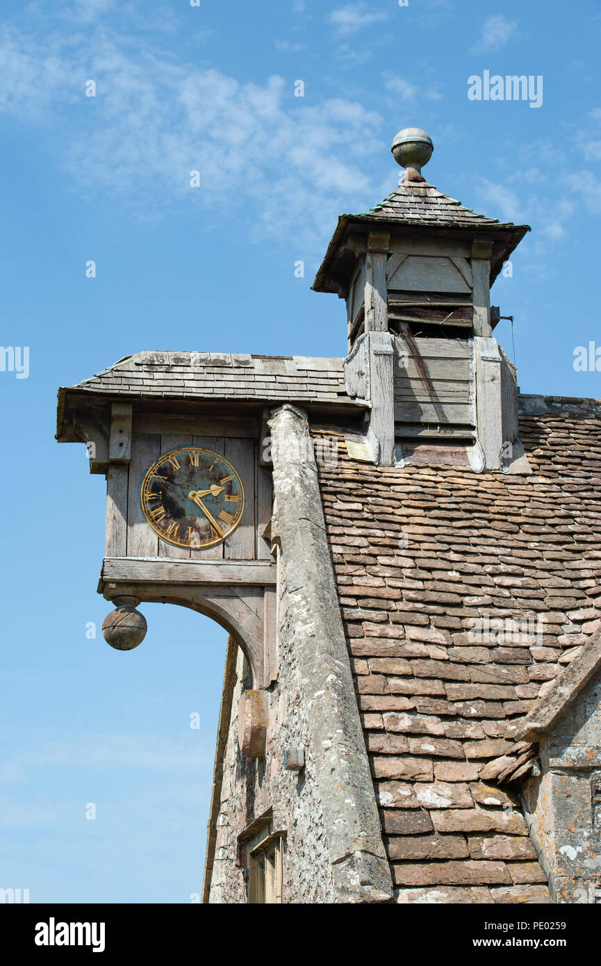 Wooden clock face and louvred bellcote on 17th Century Almshouses founded by Sir James Thynne (of Longleat House) in Longbridge Deverill,  UK. Stock Photo