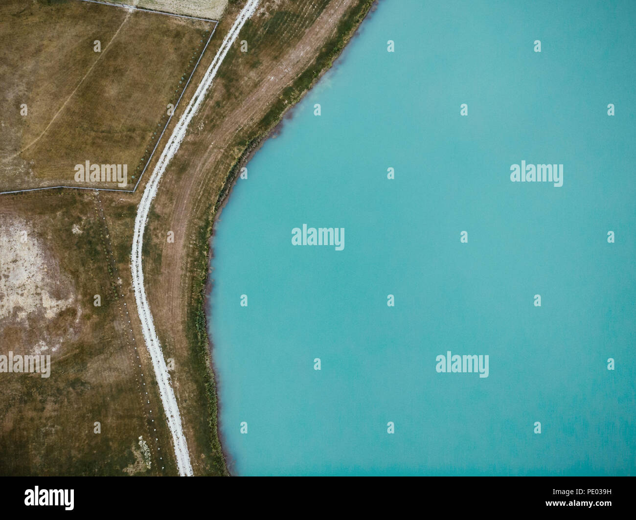 Top down aerial view over lake and rural road Stock Photo - Alamy