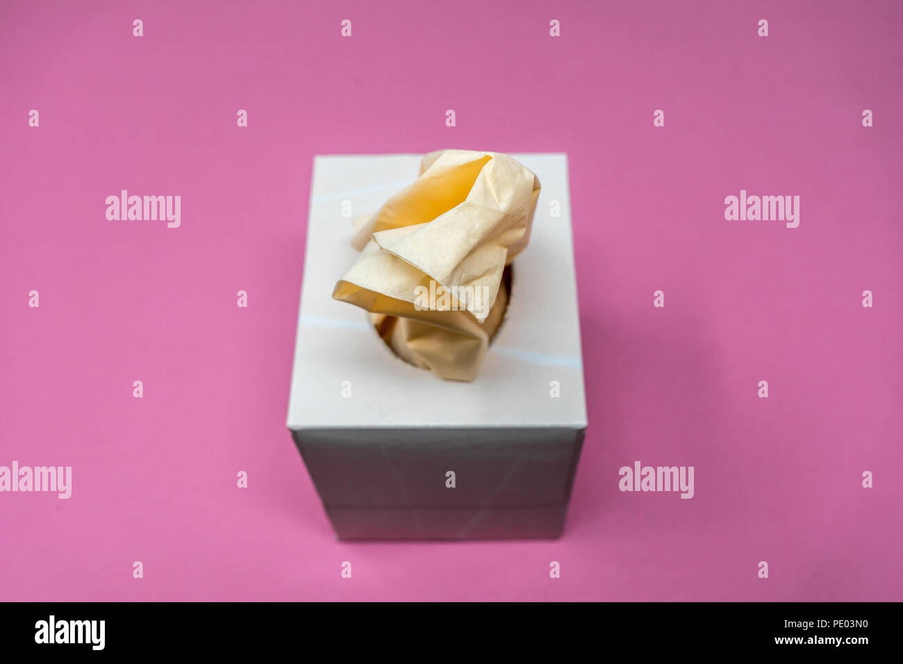 Facial Tissue Cube Box. Peach colored tissue paper. Stock Photo