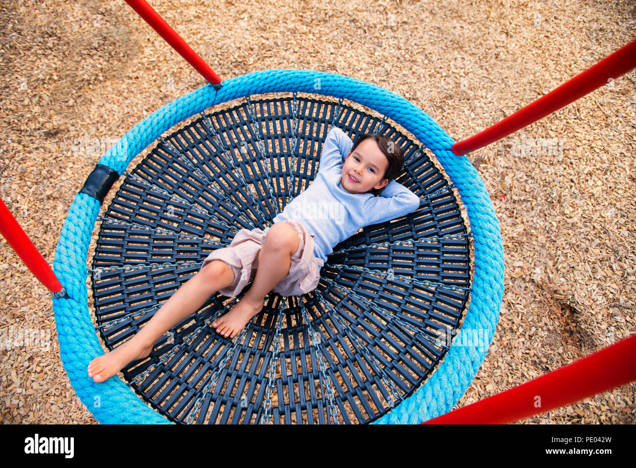 Little girl having fun in one rounded swing Stock Photo