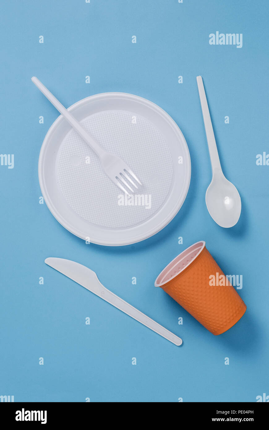 Set of white plastic utensils on a blue background Stock Photo