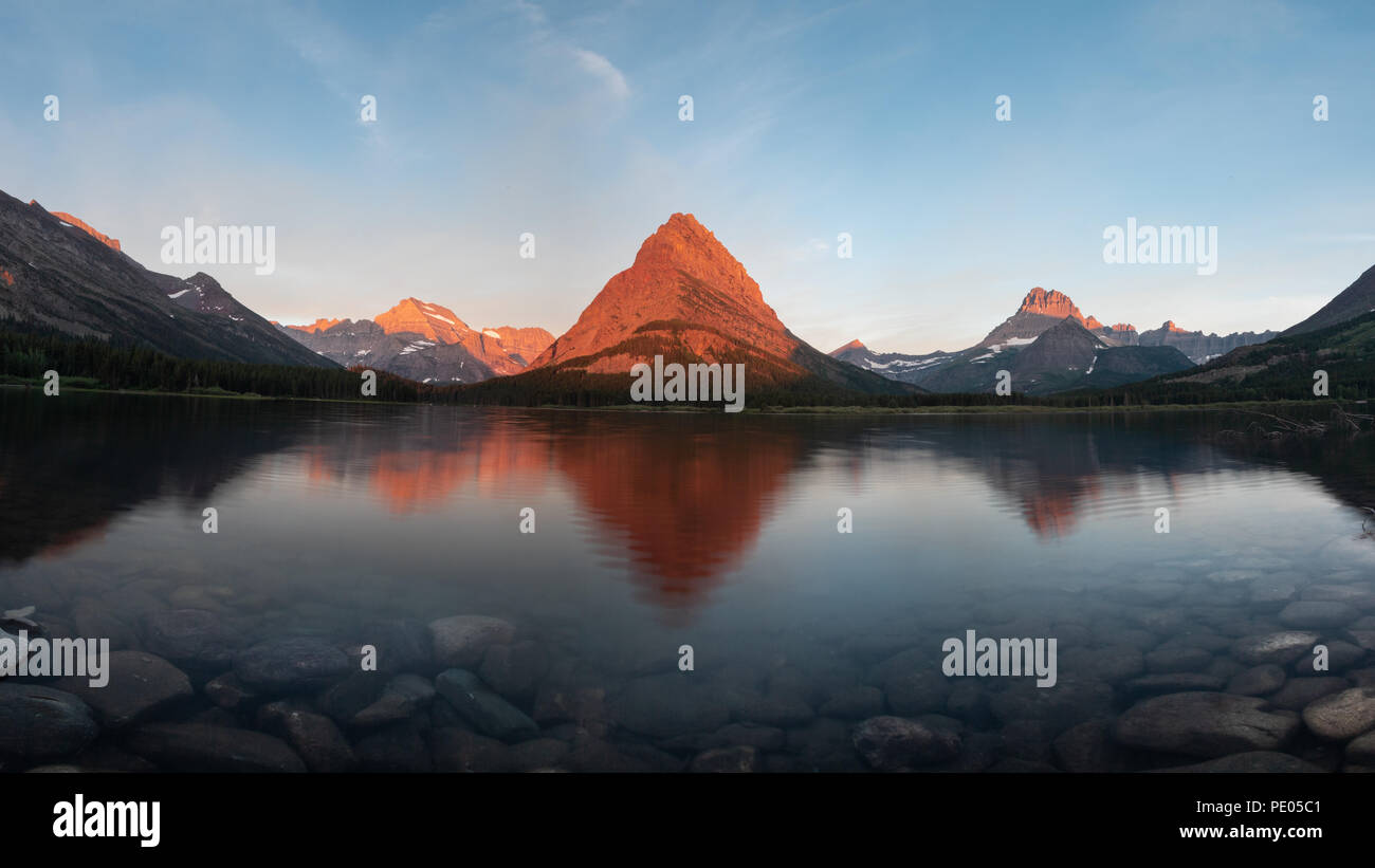 This is the picture of reflection of mountain at Swiftcurrent Lake at Glacier National Park, Montana. Stock Photo