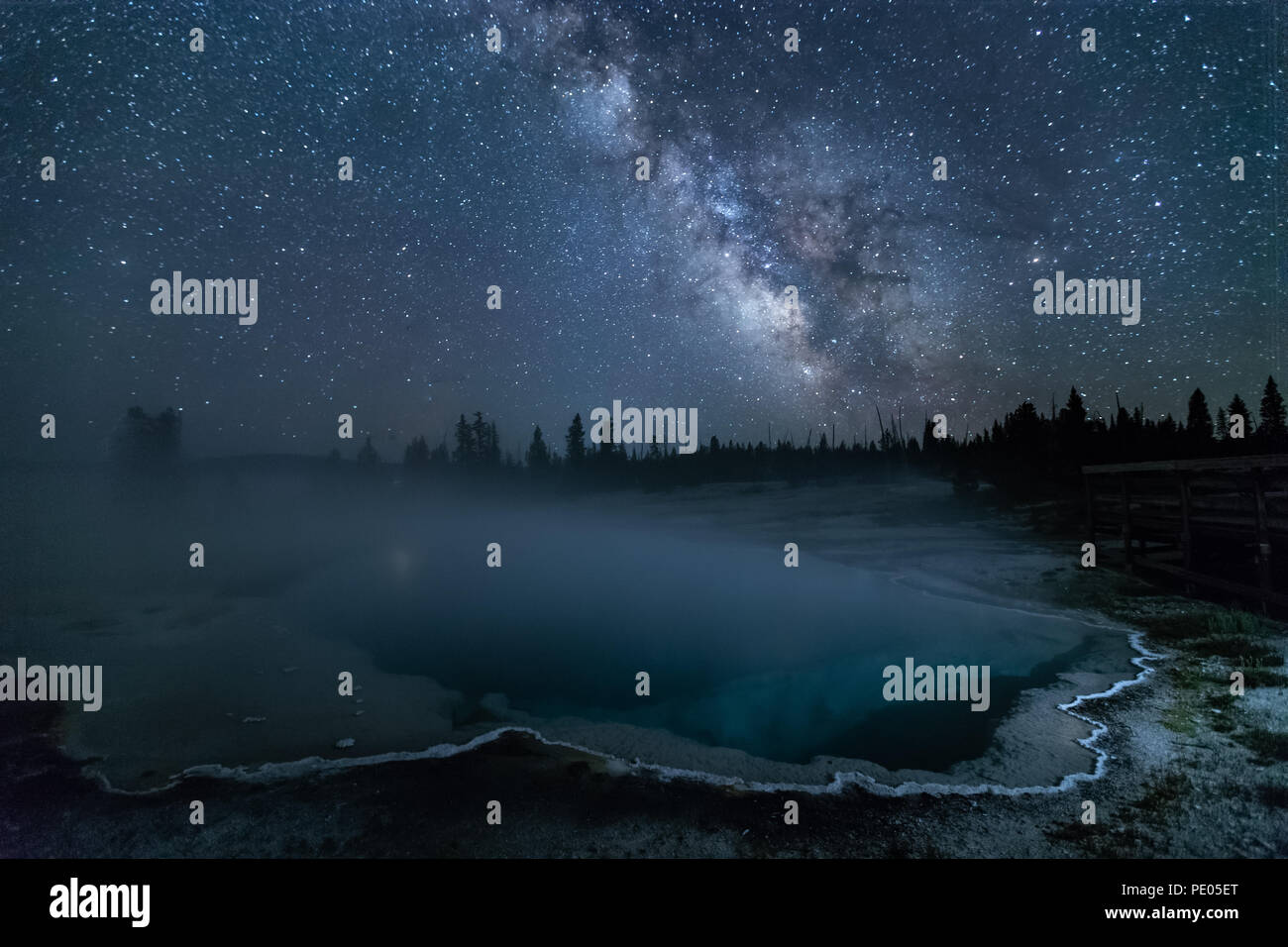 This is the picture of Black Pool at night with mikyway and stars at Yellowstone National Park, Idaho, USA. Stock Photo