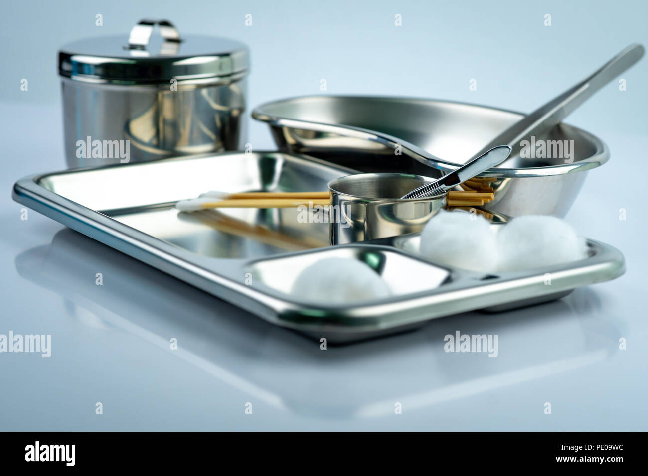 Wound care dressing set on stainless steel plate. White cotton ball