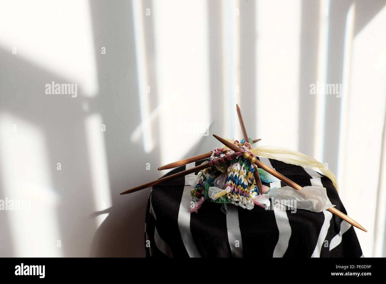 Cut nylon bag into yarn and knit to basket, good idea to recycle nylon