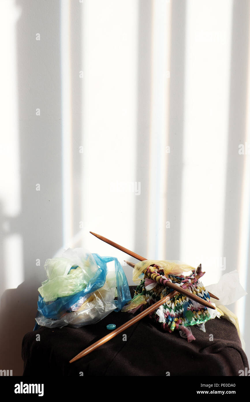 Cut nylon bag into yarn and knit to basket, good idea to recycle nylon