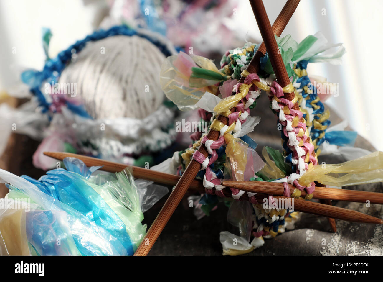 Cut nylon bag into yarn and knit to basket, good idea to recycle nylon