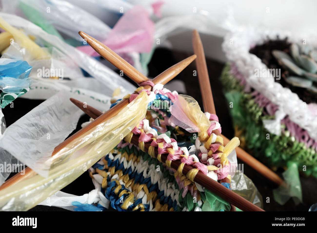 Cut nylon bag into yarn and knit to basket, good idea to recycle nylon