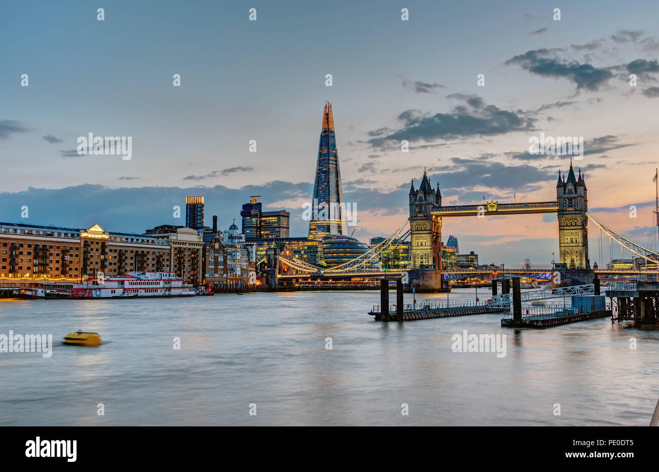 The skyline of London with the Tower Bridge and the Shard after sunset Stock Photo