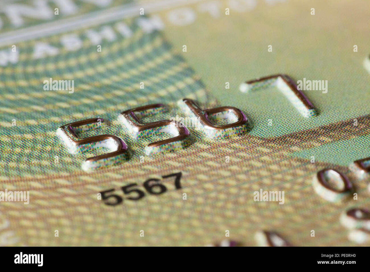 Embossed numbers on credit card close up - USA Stock Photo