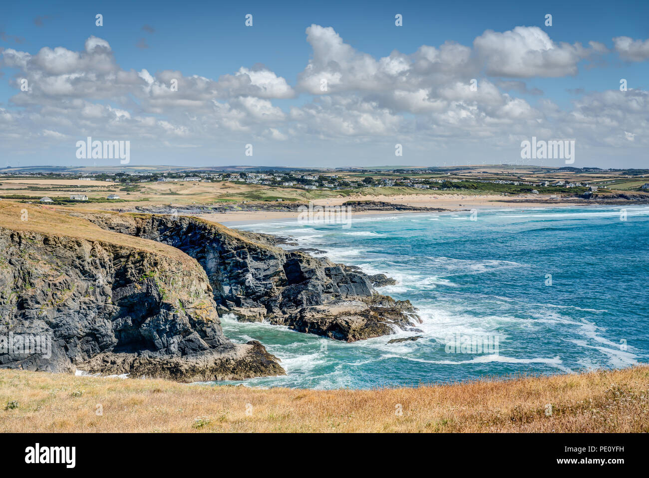 A view from Dinas Head looking back to Booby's Bay and Contantine beach on a beautiful sunny day. Blue Atlantic sea breaking on the rugged coastline. Stock Photo