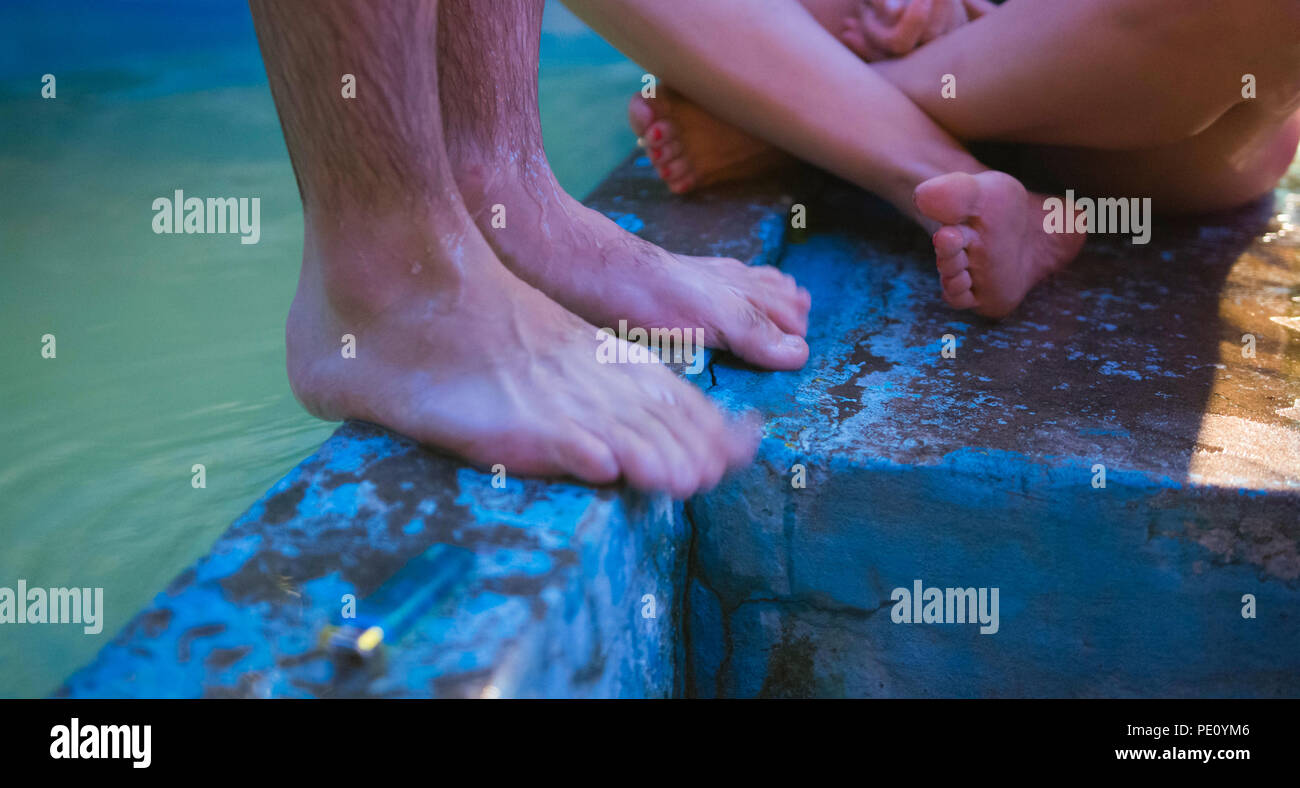 Two people enjoying themselves by the pool Stock Photo