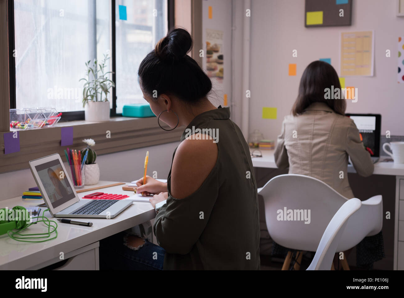 Fashion designers working on laptop in design studio Stock Photo