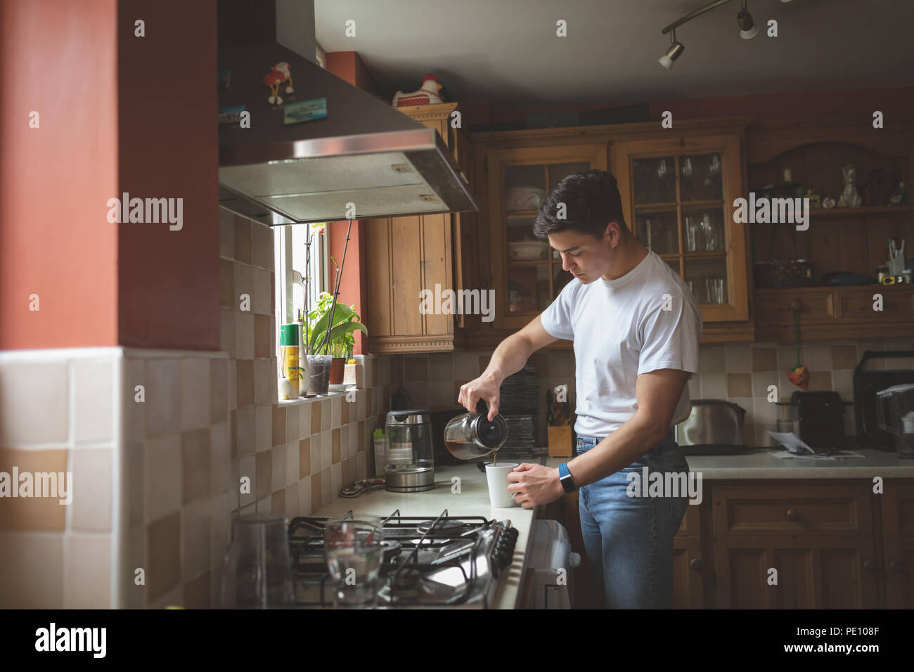 Man preparing coffee in the kitchen Stock Photo