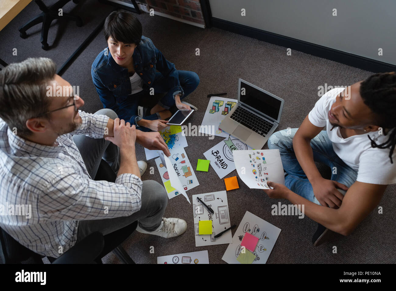 Colleagues discussing about the work over documents Stock Photo