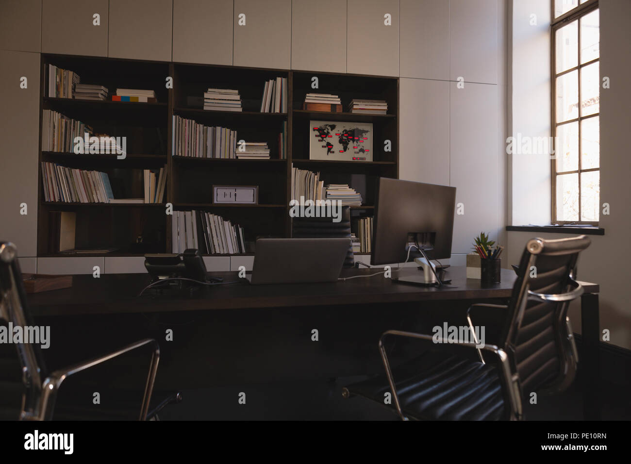 Book shelf and desk in office Stock Photo - Alamy