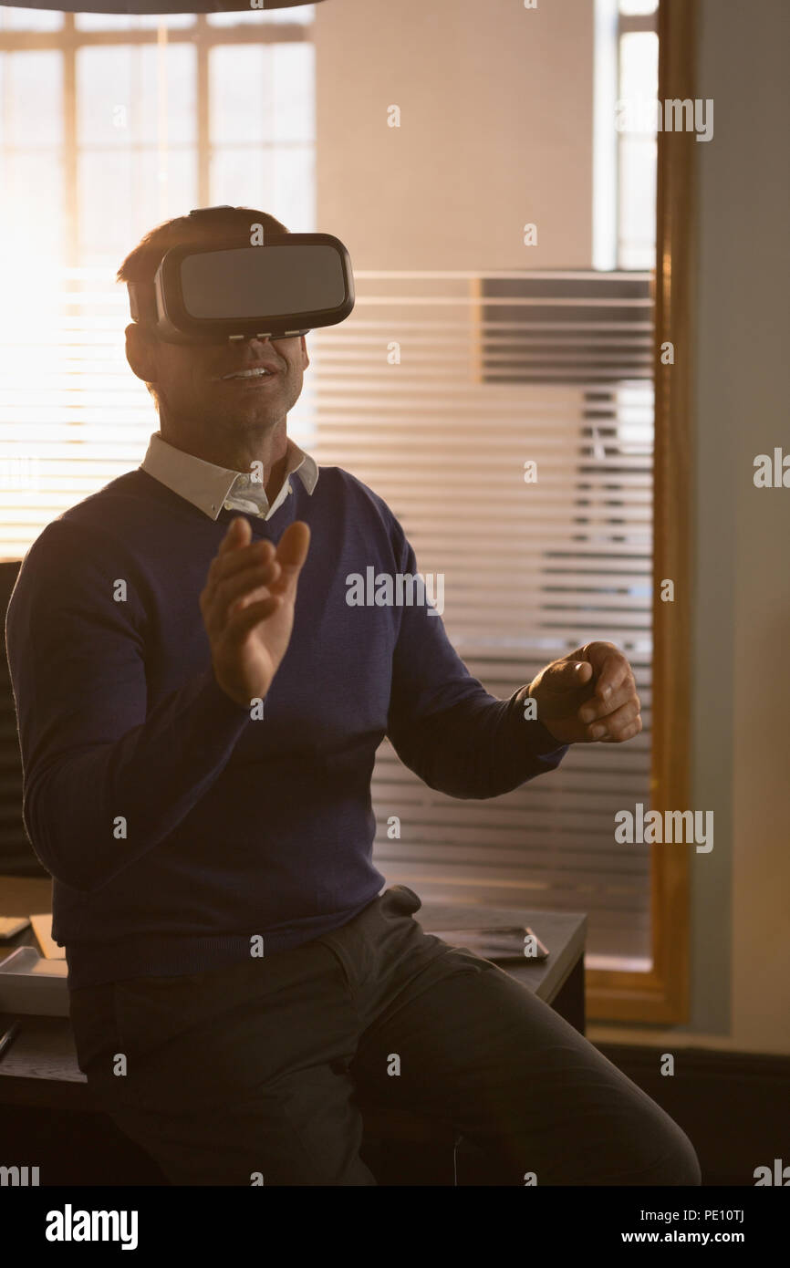 Businessman using virtual reality headset in the office Stock Photo