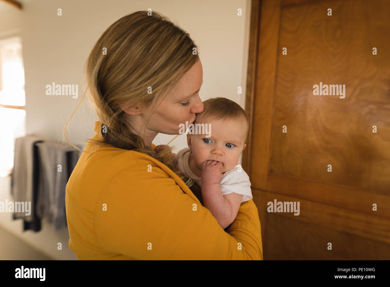 Mother kissing her baby boy Stock Photo